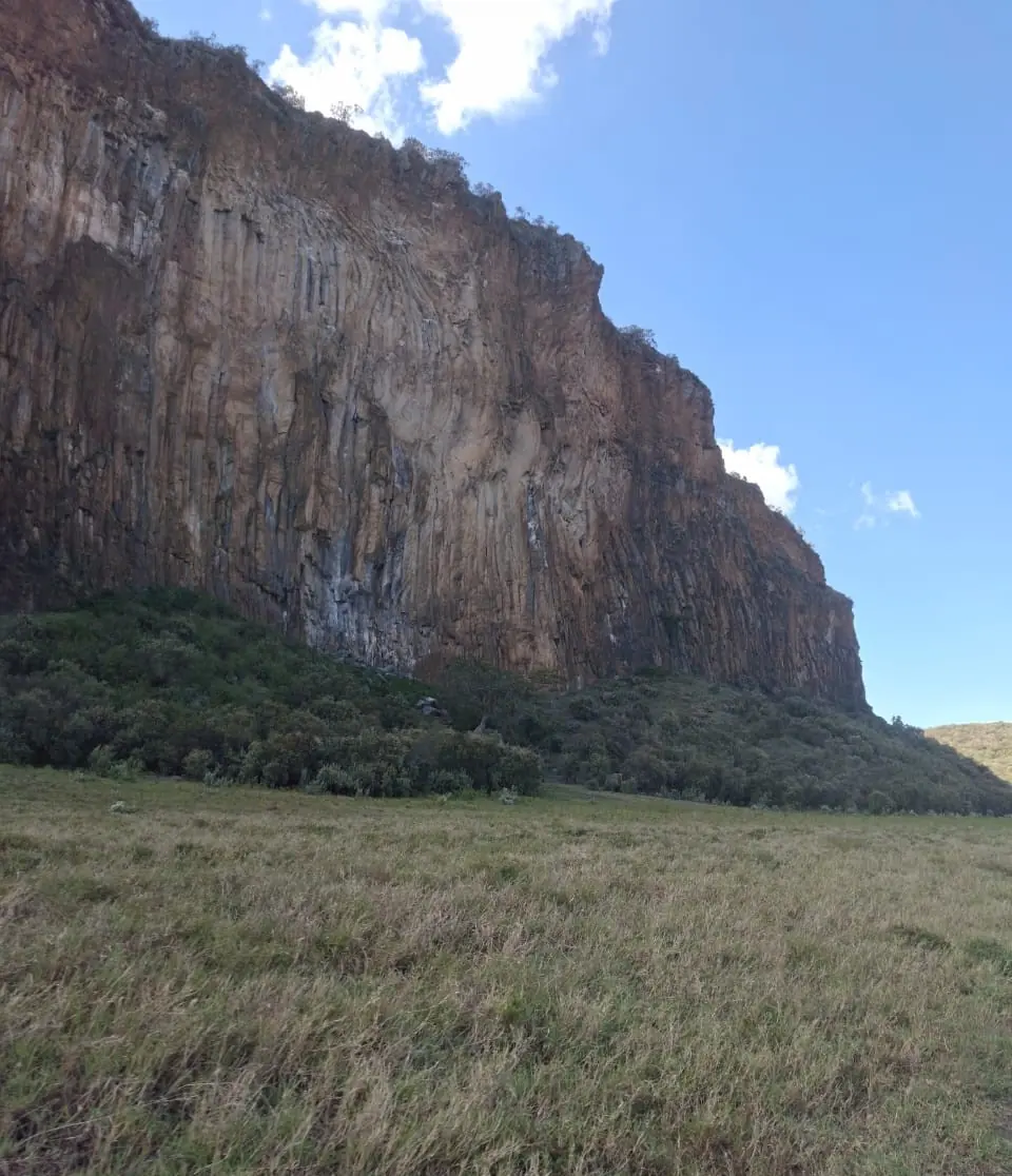 Towering volcanic cliffs above the grassland at Hell's Gate National Park