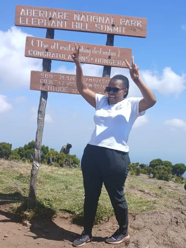 Cypress Bush Explorers co-founder celebrating at the Elephant Hill summit, Aberdare National Park