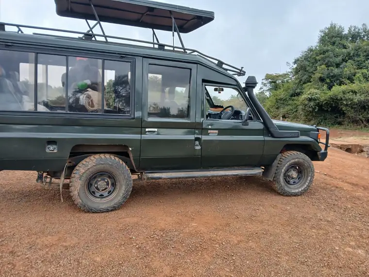 A safari Land Cruiser with its pop-up roof raised