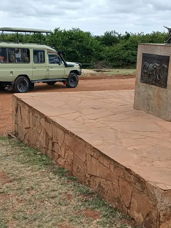 A safari vehicle parked beside an elephant monument