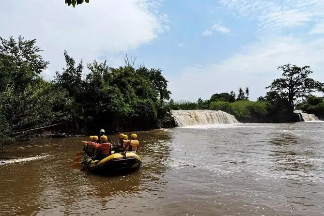 Rafters paddling below a waterfall on the Sagana River